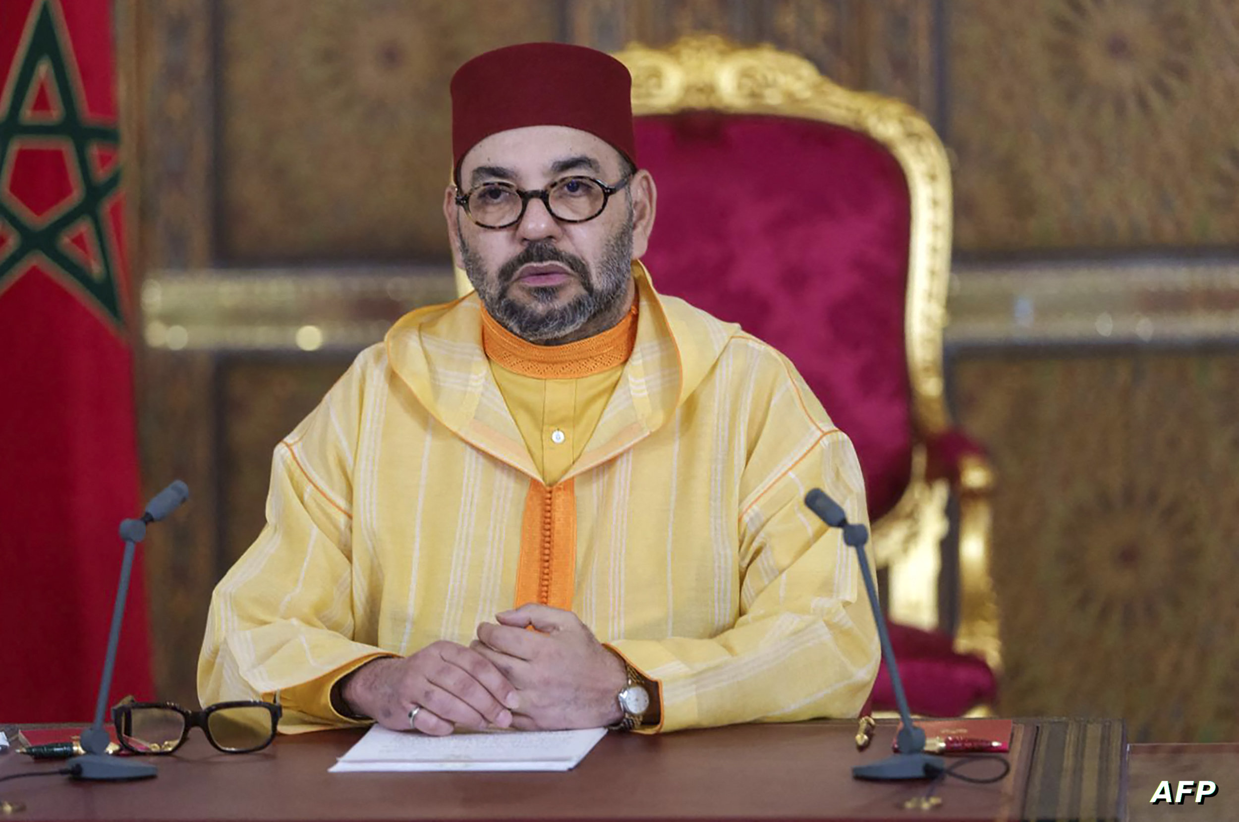 A picture released by the Moroccan Royal Palace shows Morocco's King Mohammed VI addressing speech, transmitted via a screen to the parliament, from the Royal Palace in the northeastern city of Fez, on October 8, 2021. Mohammed VI named a new government led by Aziz Akhannouch, a billionaire tycoon close to the palace who will face pressing economic problems exacerbated by the coronavirus pandemic. The 24-member cabinet, formed after Akhannouch's National Rally of Independents (RNI) trounced incumbent Islamists in elections last month, includes seven women, up from four in the previous administration. (Photo by Moroccan Royal Palace / AFP) / RESTRICTED TO EDITORIAL USE - MANDATORY CREDIT "AFP PHOTO / SOURCE / MOROCCAN ROYAL PALACE- NO MARKETING NO ADVERTISING CAMPAIGNS - DISTRIBUTED AS A SERVICE TO CLIENTS