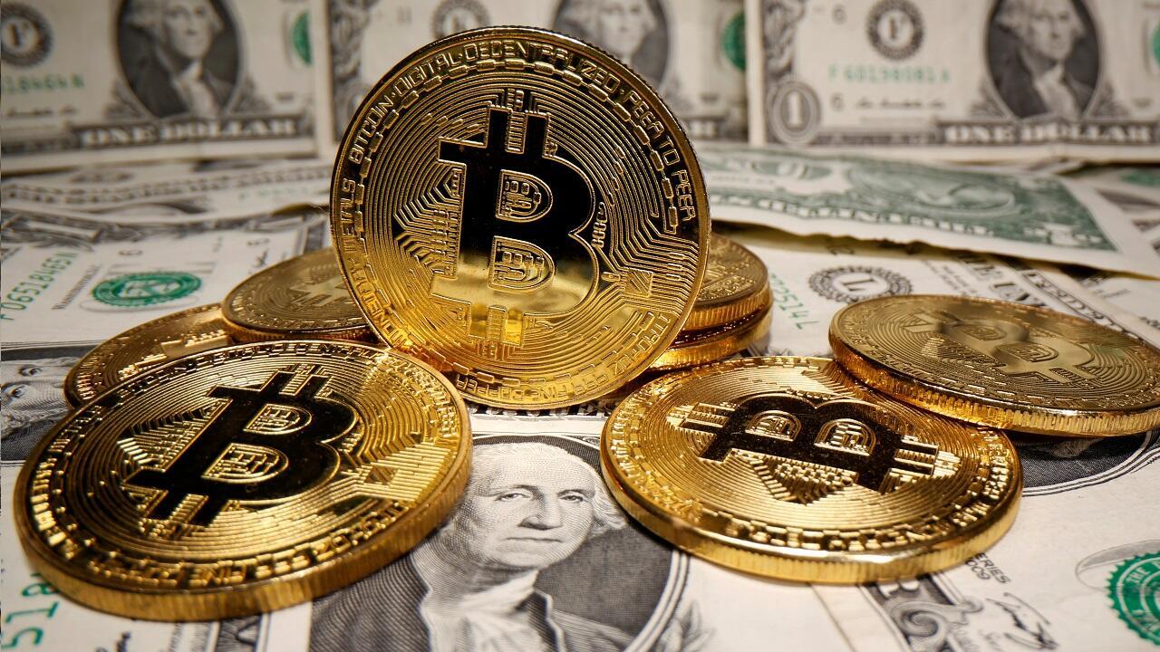 FILE PHOTO: Representations of virtual currency Bitcoin are placed on U.S. Dollar banknotes in this illustration taken May 26, 2020. REUTERS/Dado Ruvic/Illustration/File Photo